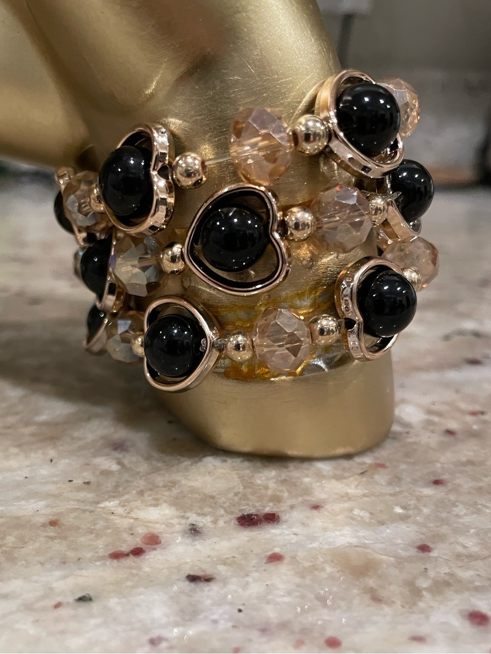 Stack of 3 Gold-Tone Bracelet w/ Black Beads encased in Heart accents.